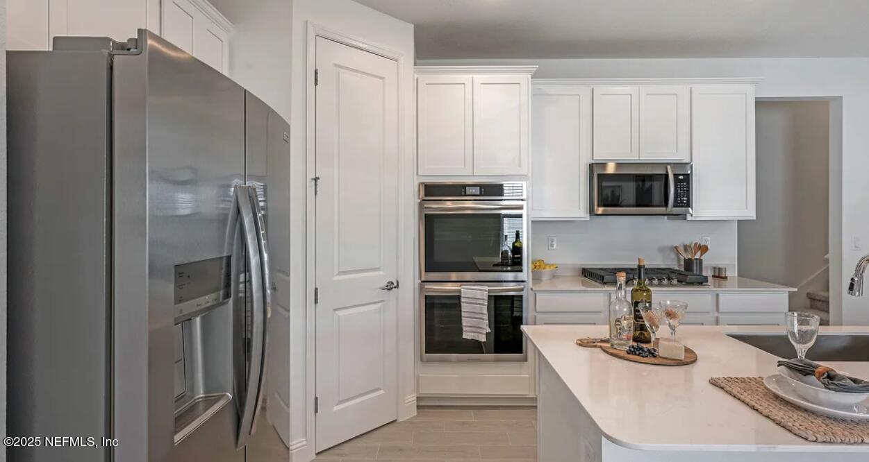 3125 Adelaide Road Green Cove Springs, FL 32043 - Photo 36 of 47 a kitchen with stainless steel appliances a refrigerator stove and microwave