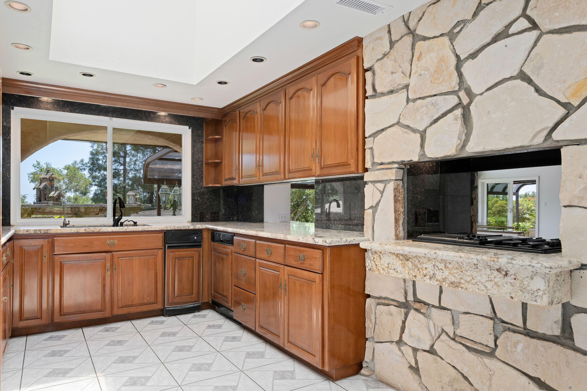 2106 Mt Calvary Road Santa Barbara, CA 93105 - Photo 18 of 66 a kitchen with stainless steel appliances granite countertop a stove sink and cabinets