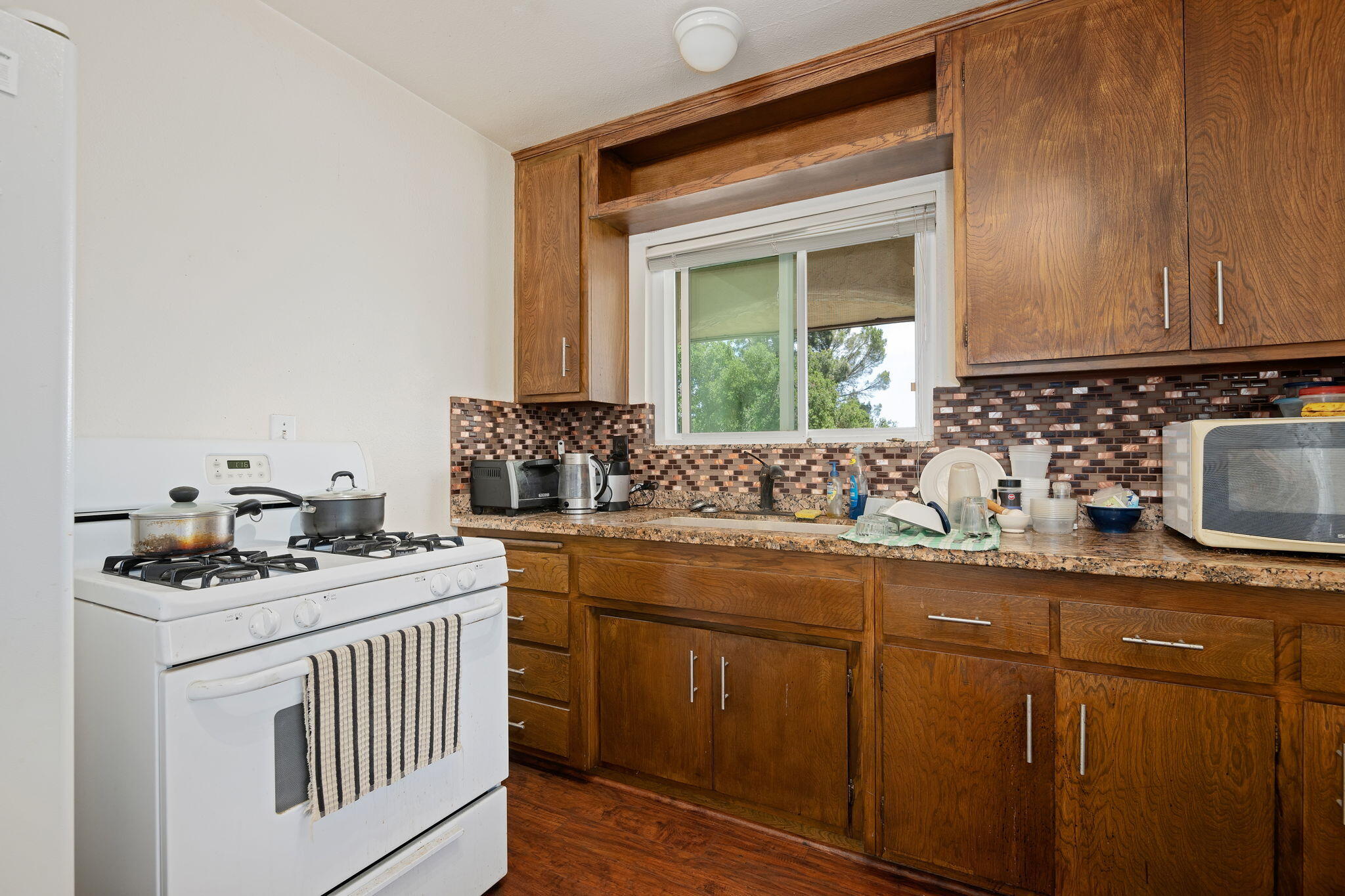 2106 Mt Calvary Road Santa Barbara, CA 93105 - Photo 45 of 66 a kitchen with stainless steel appliances granite countertop a sink stove cabinets and a window