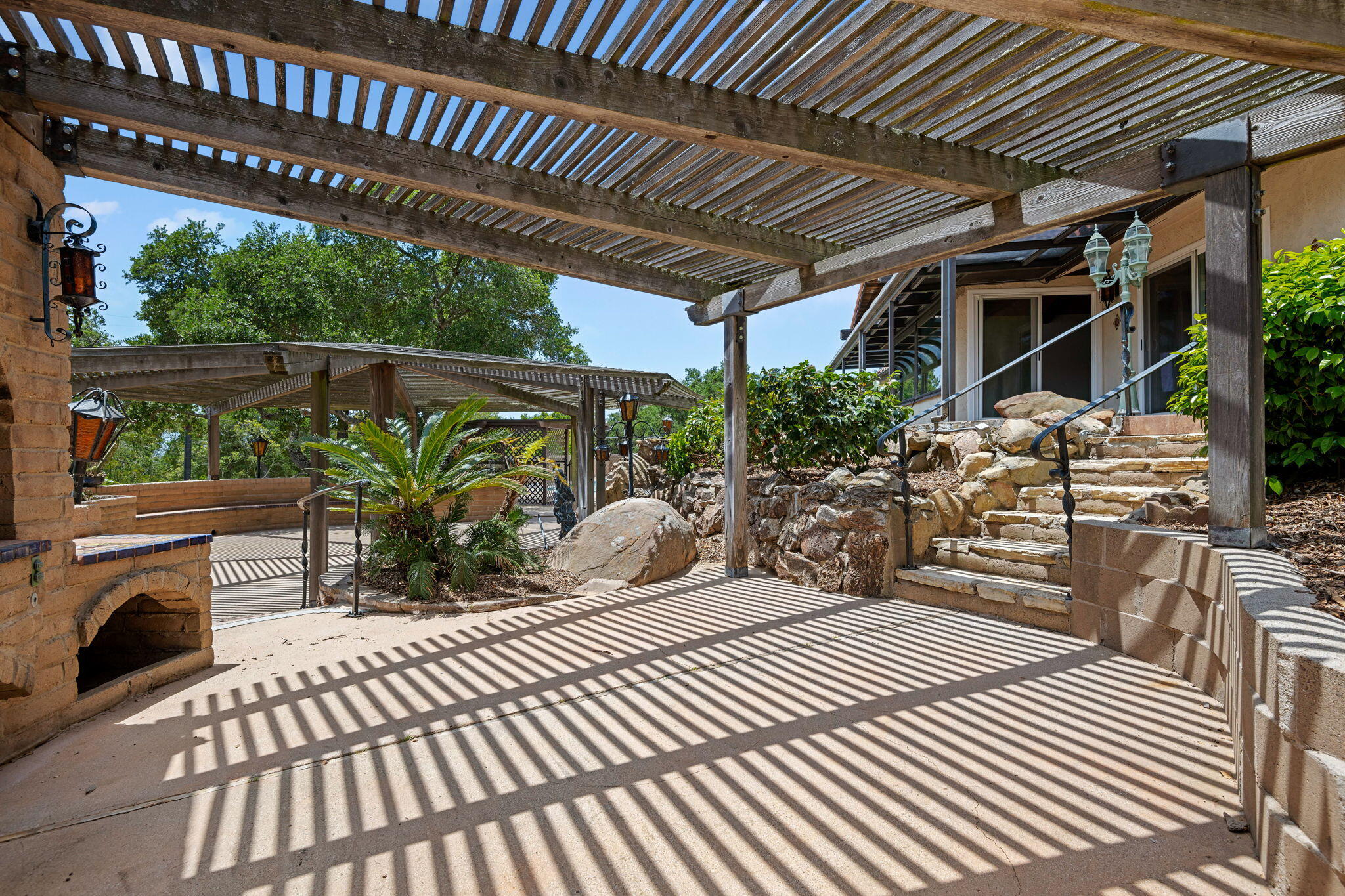 2106 Mt Calvary Road Santa Barbara, CA 93105 - Photo 55 of 66 a view of a patio with table and chairs potted plants and large tree