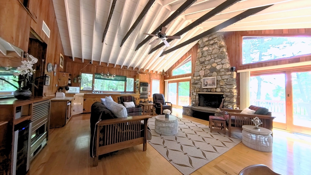 32 Pond Hill Road Goshen, MA 01096 - Photo 8 of 24 a living room with furniture a fireplace and a floor to ceiling window
