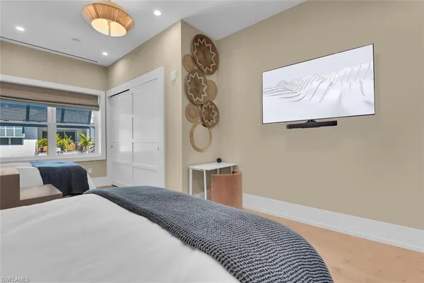 a bedroom with a bed and a painting on the wall