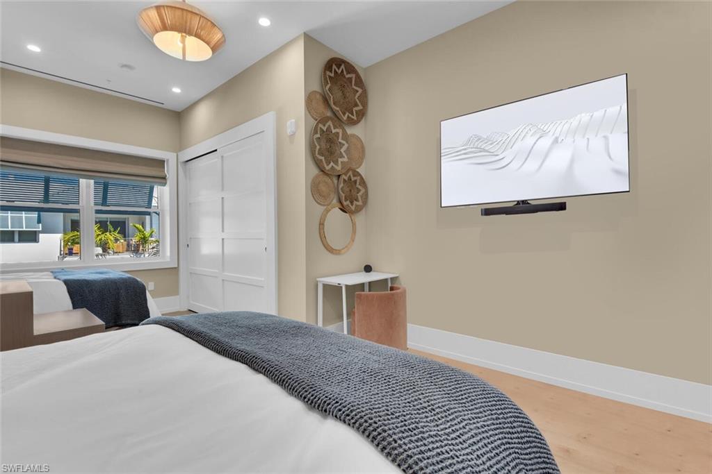 201 8th Street South, Unit 311 Naples, FL 34102 - Photo 13 of 39 Bedroom featuring baseboards, recessed lighting, wood finished floors, and a closet