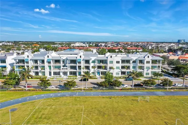 an aerial view of residential building and lake
