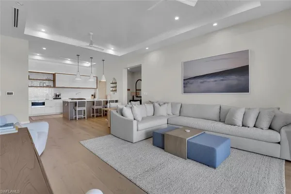 a living room with furniture and kitchen view