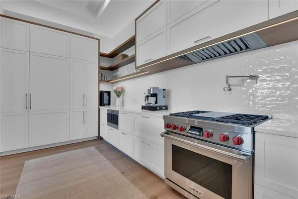 a kitchen with a stove and a microwave
