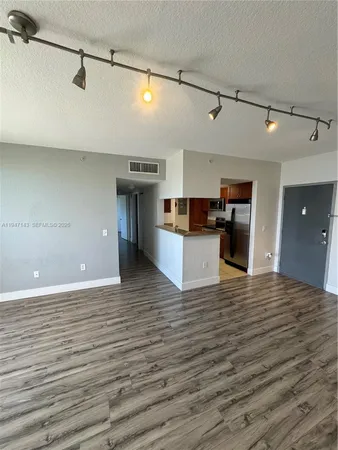 a view of a kitchen with a sink and wooden floor