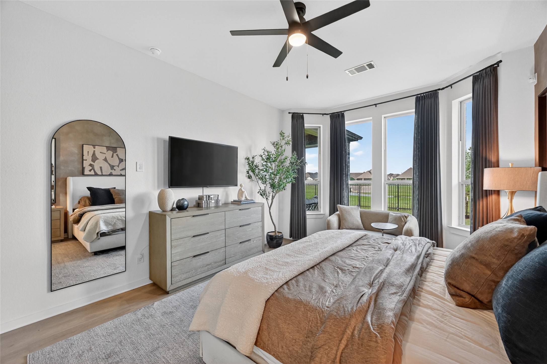4439 Stone Ridge Lane Manvel, TX 77578 - Photo 22 of 48 a bedroom with a bed a flat screen tv and a couch