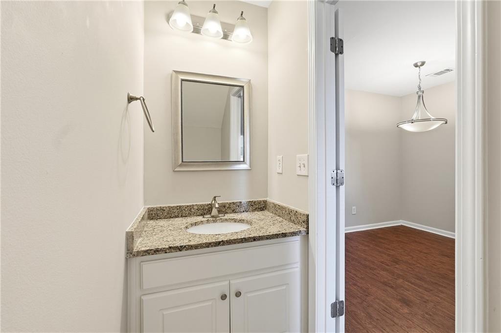 1468 Box Circle Winder, GA 30680 - Photo 11 of 25 a bathroom with a granite countertop sink a toilet and a mirror