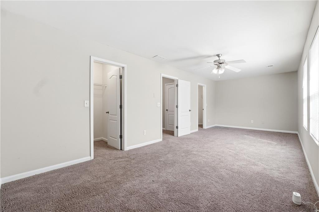 1468 Box Circle Winder, GA 30680 - Photo 18 of 25 a view of an empty room with a chandelier fan