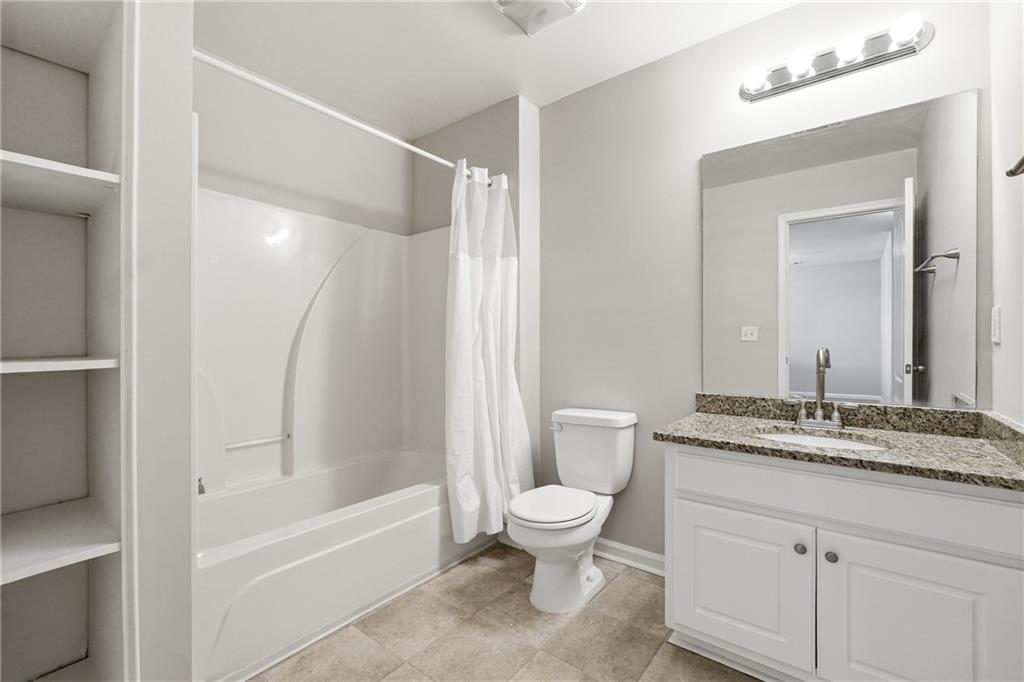 1468 Box Circle Winder, GA 30680 - Photo 20 of 25 a bathroom with a granite countertop sink toilet and shower