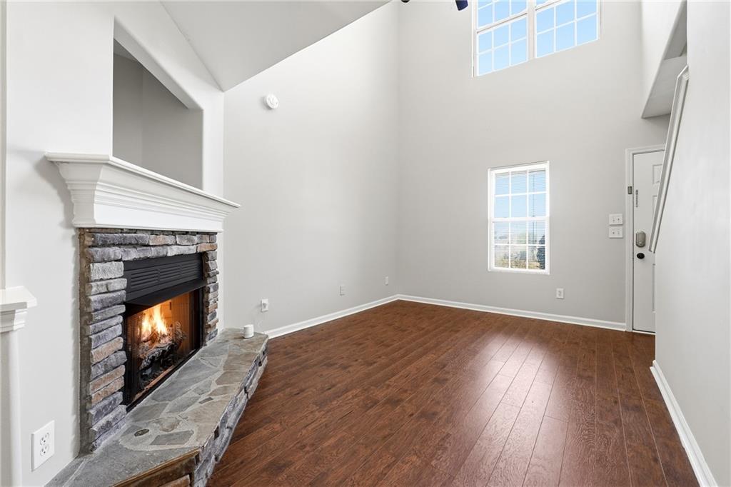 1468 Box Circle Winder, GA 30680 - Photo 5 of 25 a view of an empty room with wooden floor fireplace and a window