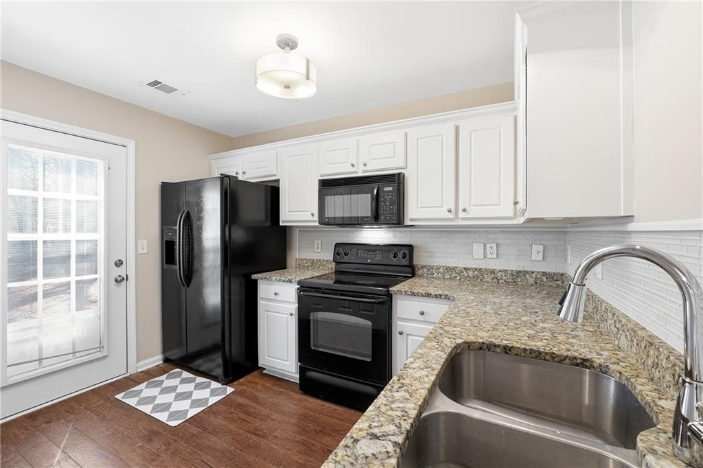 1468 Box Circle Winder, GA 30680 - Photo 8 of 25 a kitchen with granite countertop a refrigerator and a stove top oven
