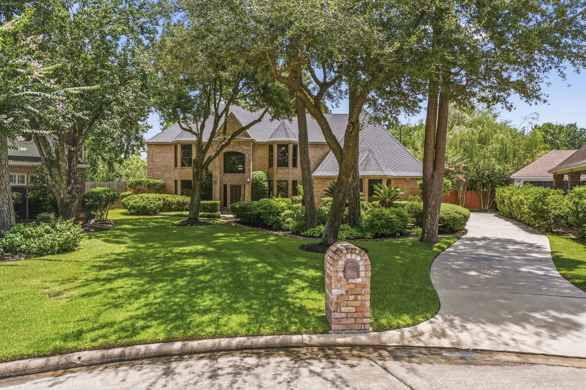 18503 Cabaniss Circle Spring, TX 77379 - Photo 4 of 49 Mature shade trees, lush landscaping, and a stately brick exterior create timeless curb appeal from the moment you arrive.