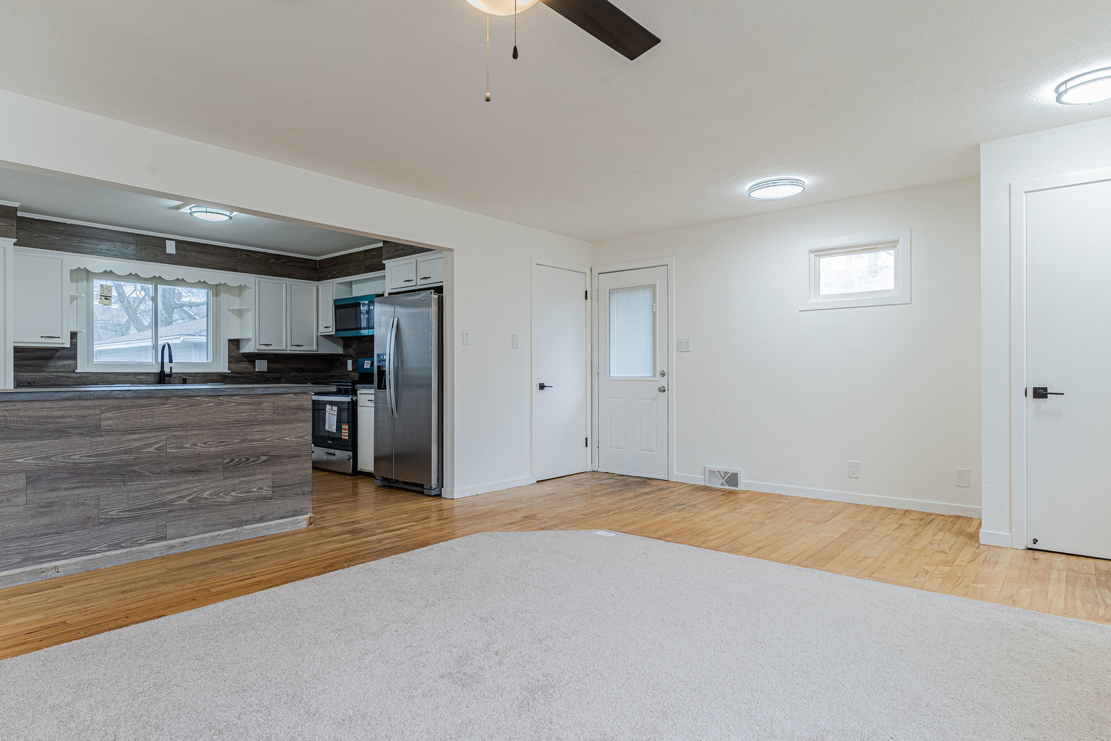 15324 South Corbin Street Plainfield, IL 60544 - Photo 6 of 26 a view of a kitchen with a sink and a refrigerator