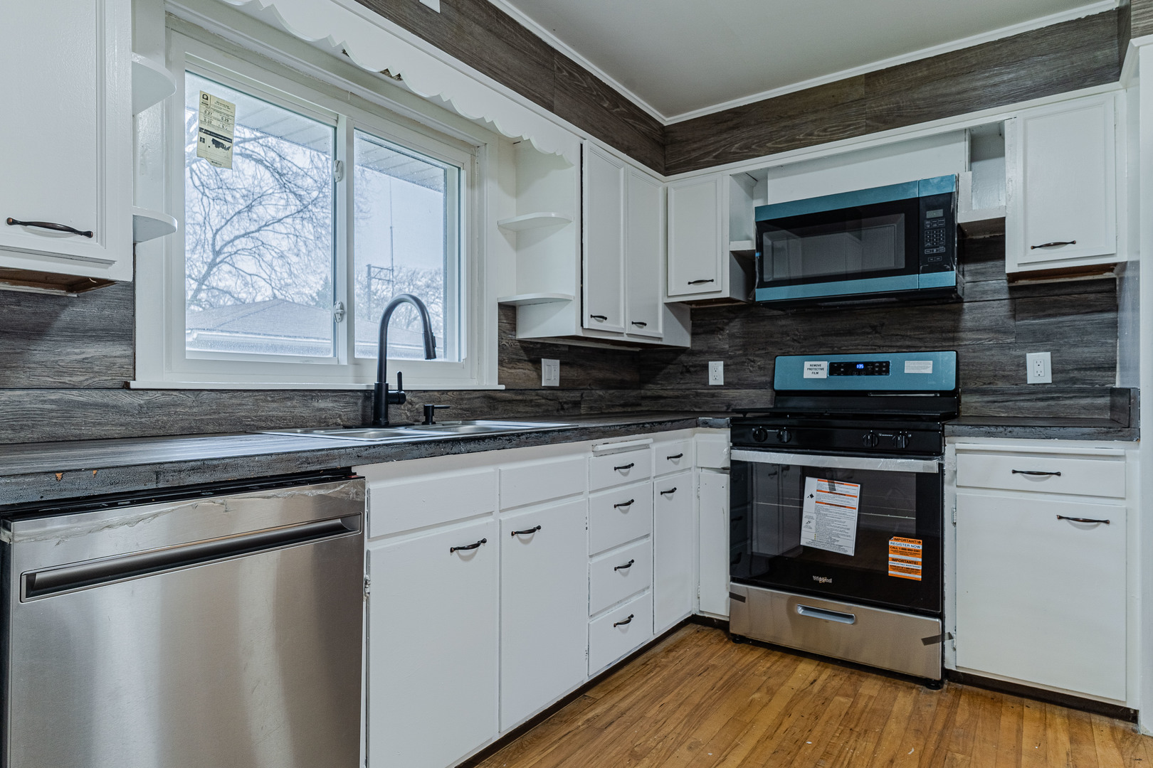 15324 South Corbin Street Plainfield, IL 60544 - Photo 8 of 26 a kitchen with stainless steel appliances a stove a sink and a microwave