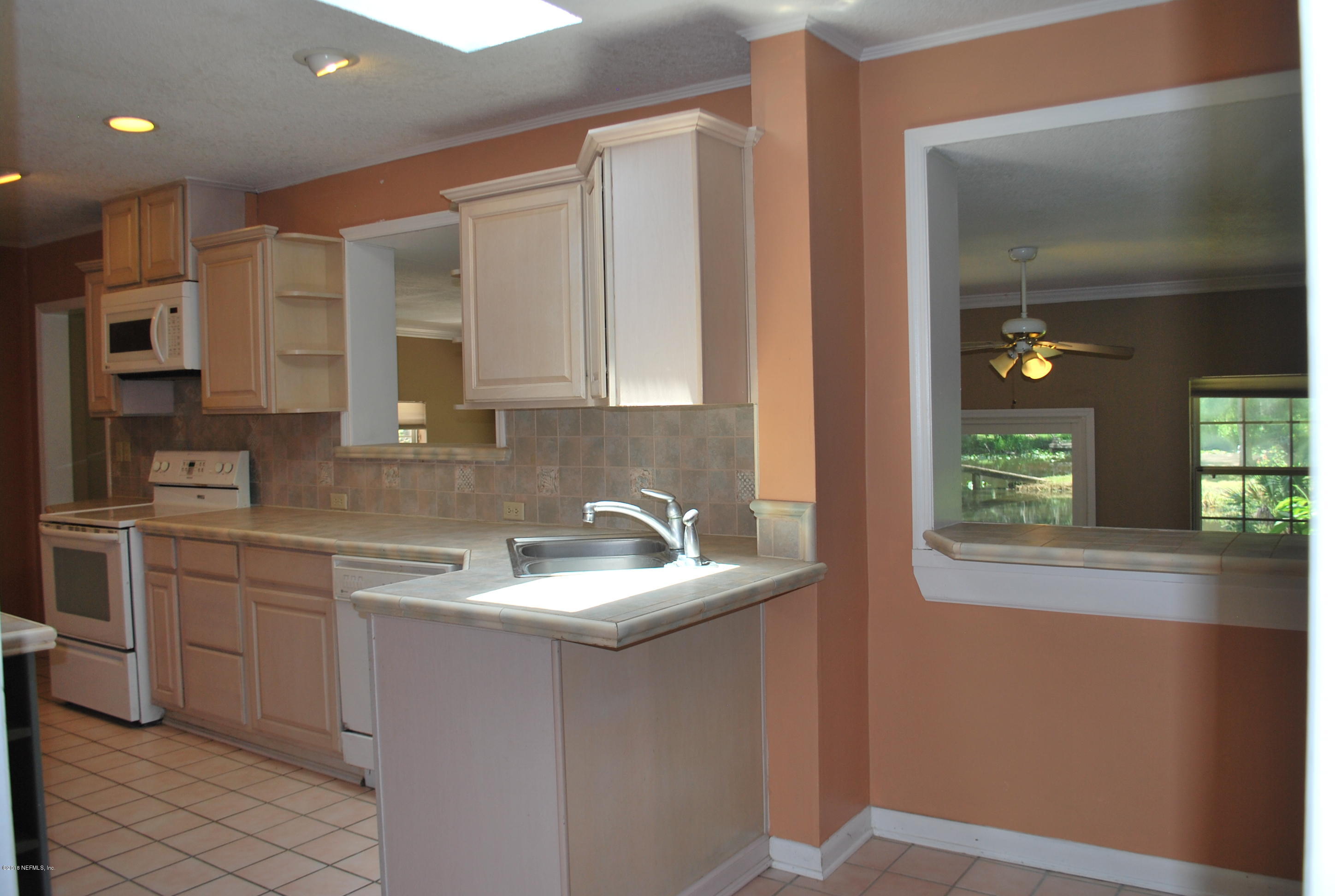 8811 Sanchez Road Jacksonville, FL 32217 - Photo 20 of 52 a kitchen with stainless steel appliances granite countertop a sink stove and cabinets