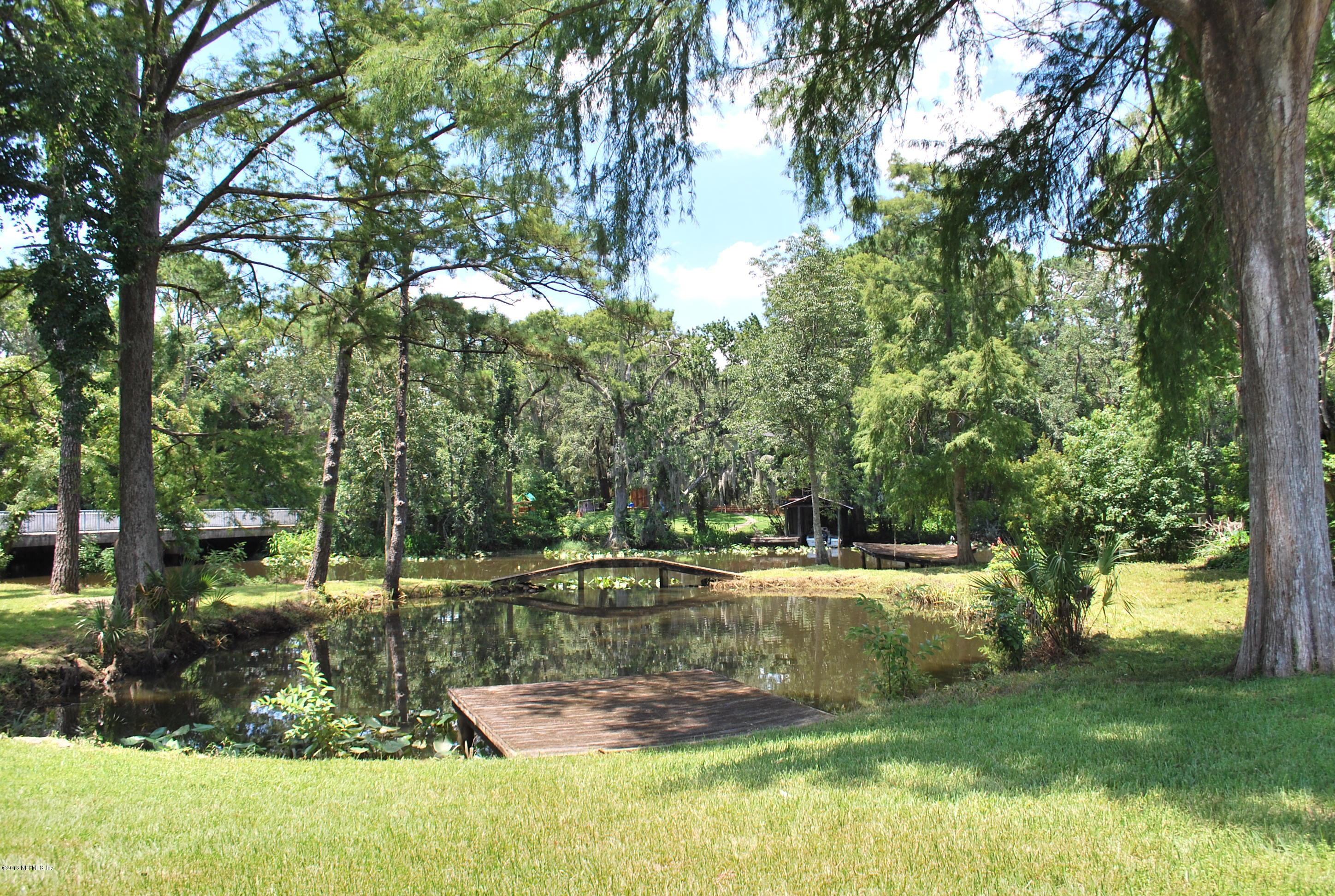 8811 Sanchez Road Jacksonville, FL 32217 - Photo 2 of 52 a view of a yard with large trees