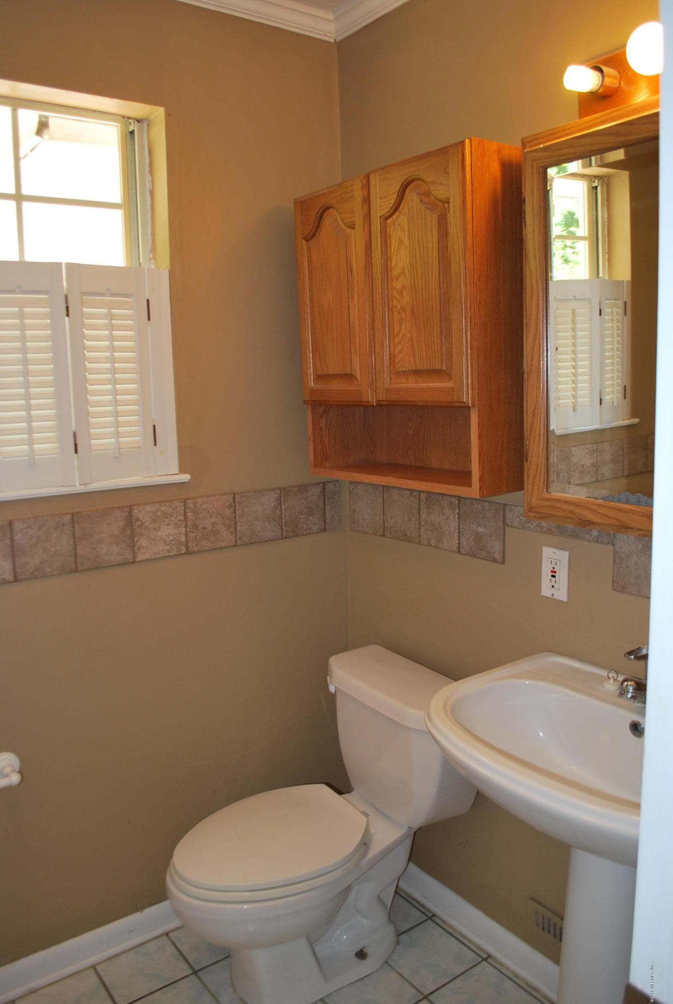 8811 Sanchez Road Jacksonville, FL 32217 - Photo 27 of 52 a white toilet sitting next to a bathroom sink