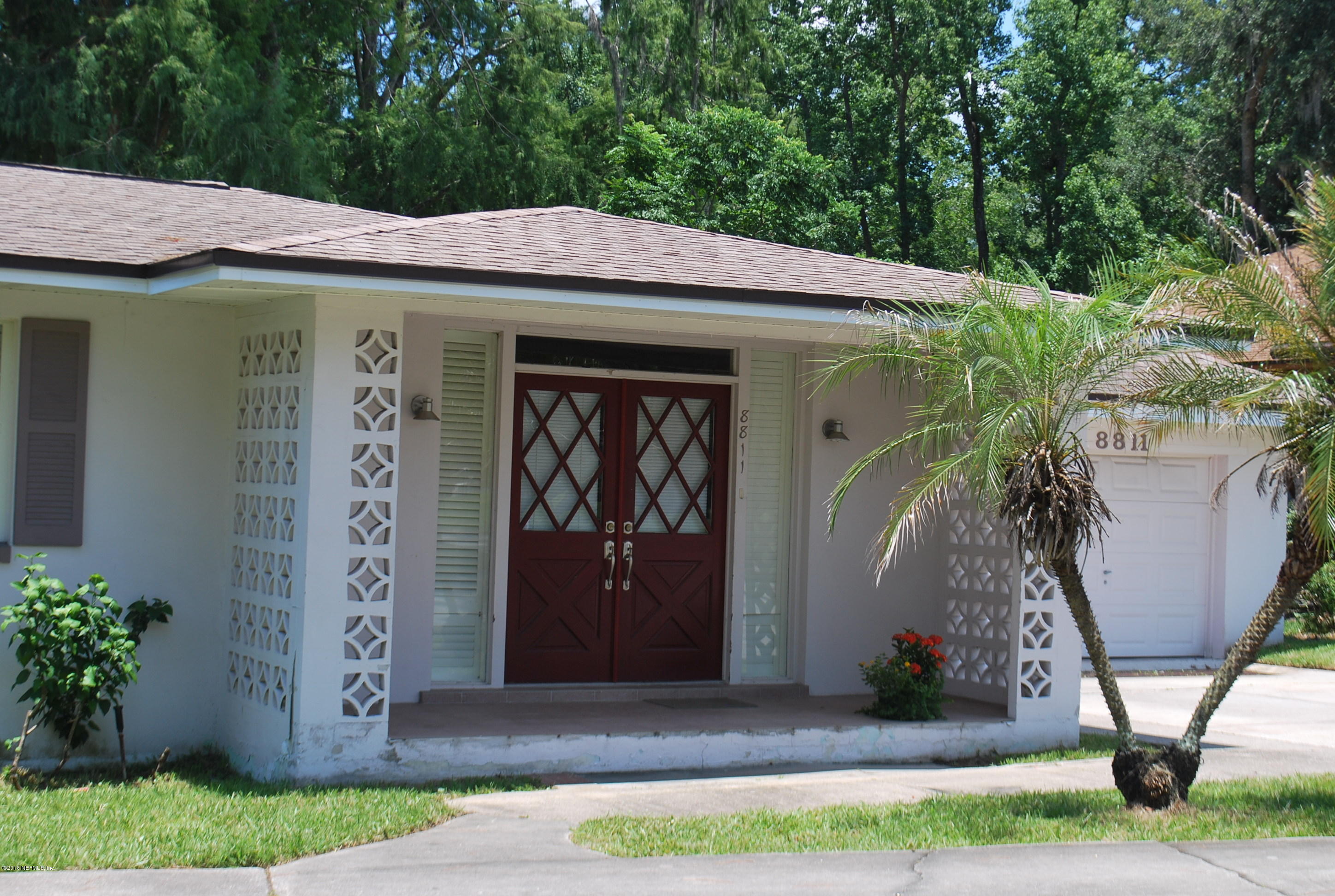 8811 Sanchez Road Jacksonville, FL 32217 - Photo 31 of 52 a view of a house with potted plants and a yard
