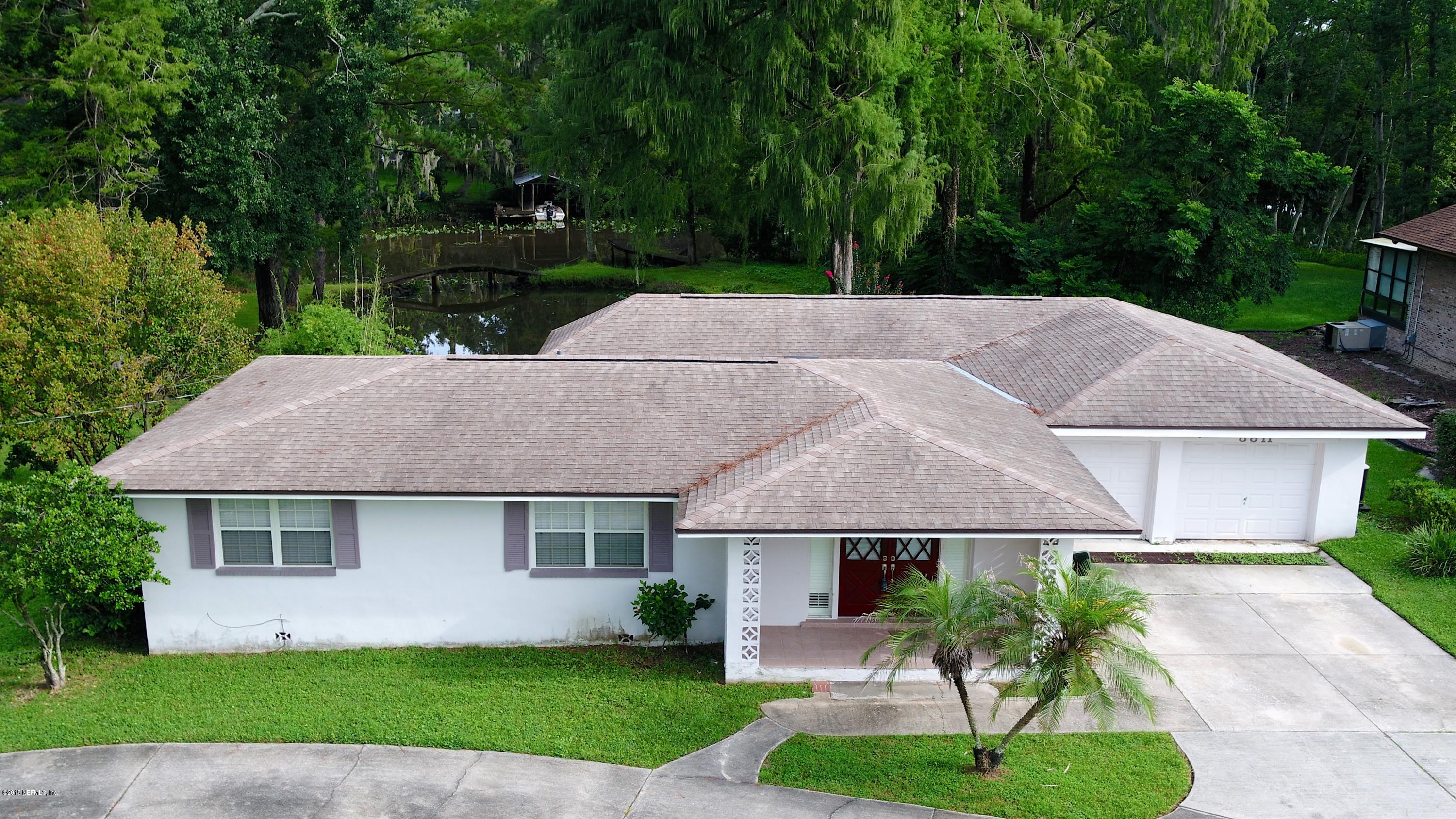 8811 Sanchez Road Jacksonville, FL 32217 - Photo 4 of 52 a aerial view of a house with a yard plants and large tree