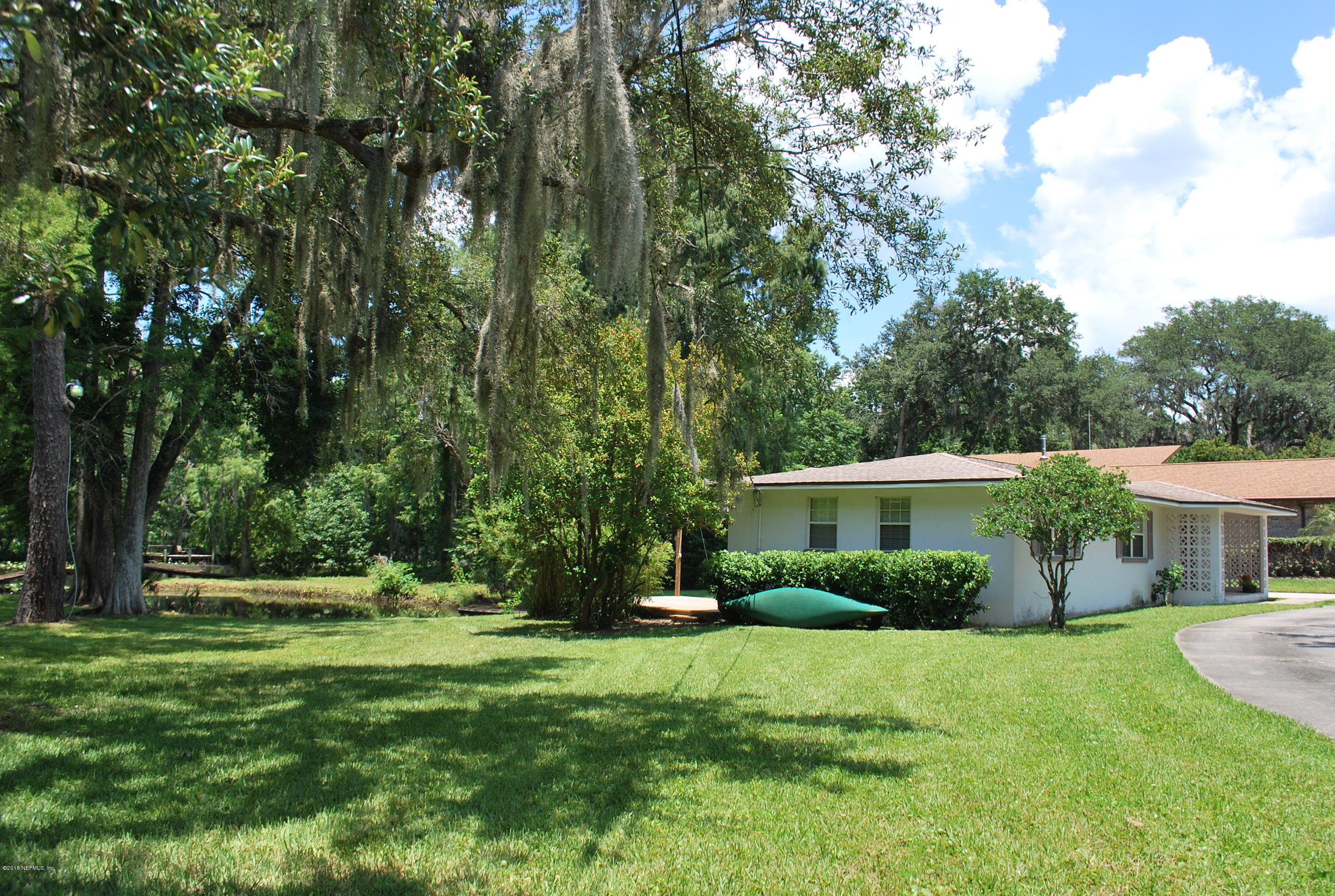 8811 Sanchez Road Jacksonville, FL 32217 - Photo 5 of 52 a front view of a house with a yard