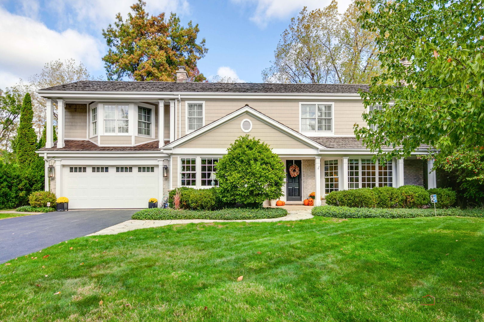 a front view of house with yard and green space