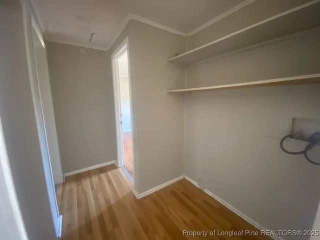 a view of a room with wooden floor