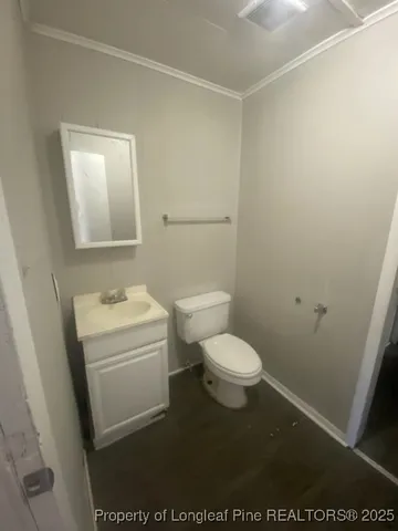 a white toilet sitting next to a bathroom sink