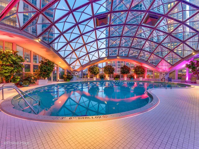 a view of a swimming pool with an outdoor space and seating area