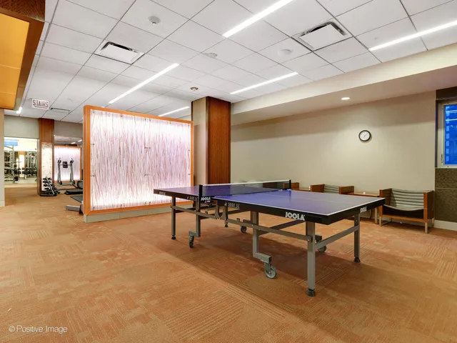 a living room with furniture a table and a large window