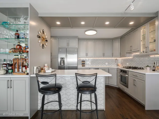 a kitchen with stainless steel appliances kitchen island granite countertop a sink and cabinets