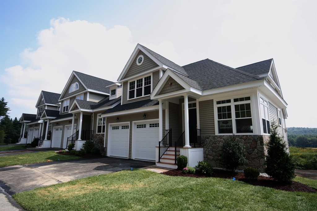 a front view of a house with a yard and porch