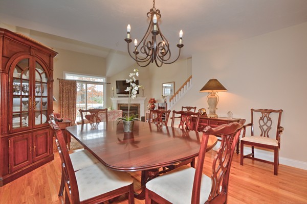 13 C Trail Ridge Way, Unit 47AR Harvard, MA 01451 - Photo 13 of 30 a dining room with wooden floor a chandelier a wooden table and chairs