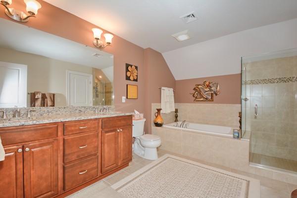 13 C Trail Ridge Way, Unit 47AR Harvard, MA 01451 - Photo 22 of 30 a spacious bathroom with a granite countertop sink a toilet a mirror a vanity a bathtub and shower