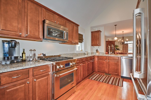 13 C Trail Ridge Way, Unit 47AR Harvard, MA 01451 - Photo 8 of 30 a kitchen with stainless steel appliances granite countertop a stove a sink dishwasher and cabinets with wooden floor