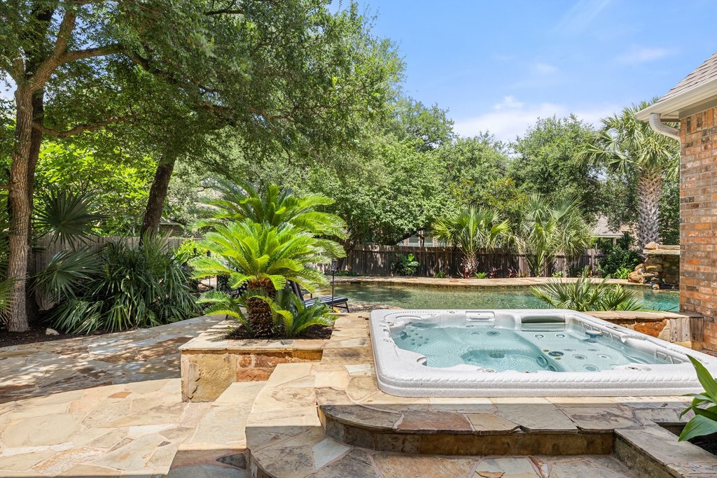 6704 Kiev Cove Austin, TX 78739 - Photo 34 of 37 An inviting backyard oasis offers a sparkling in-ground pool and an elevated private spa.