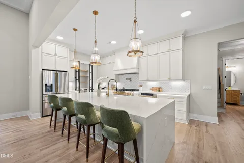 a kitchen with white cabinets and sink