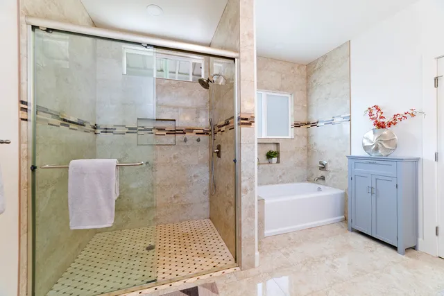a bathroom with a bathtub shower and a sink