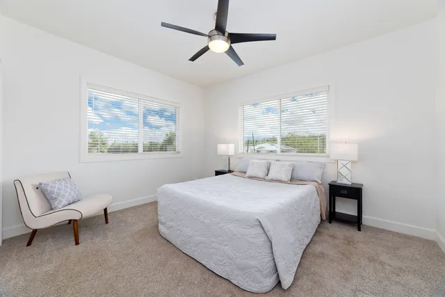 a bedroom with a bed couch and window