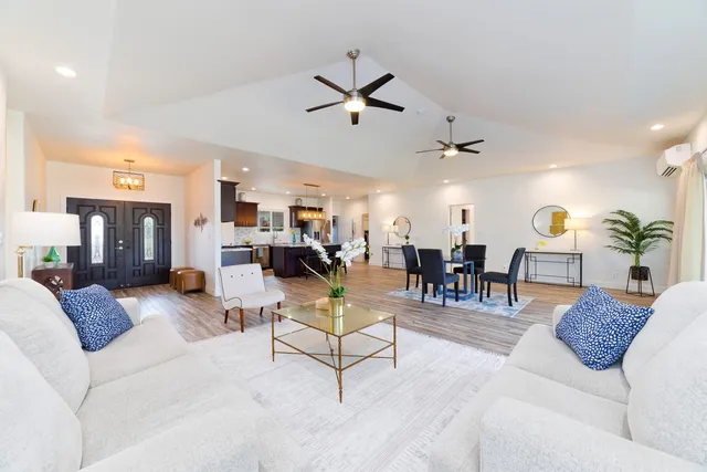 a living room with furniture and wooden floor