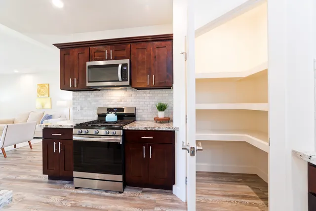 a kitchen with stainless steel appliances a stove and a microwave