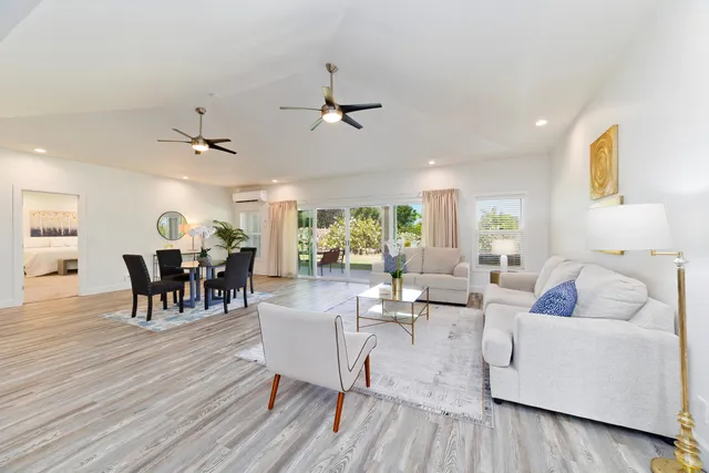 a living room with furniture dining table and wooden floor