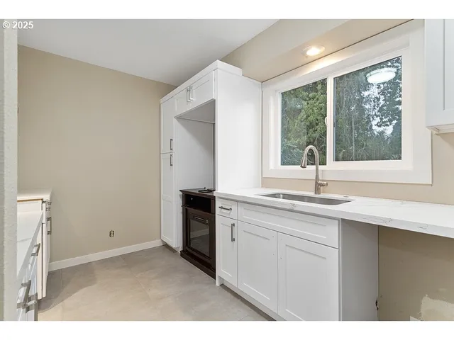 a kitchen with a sink and large window