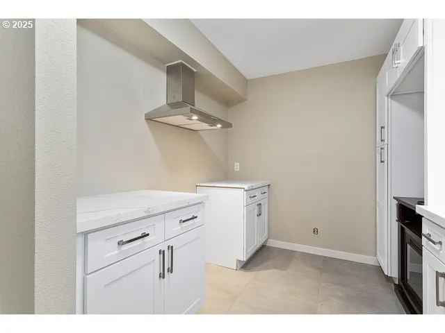 a utility room with cabinets washer and dryer