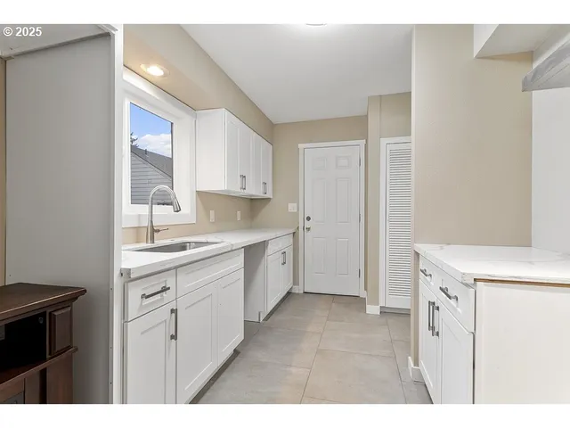 a kitchen with a sink stove and cabinets