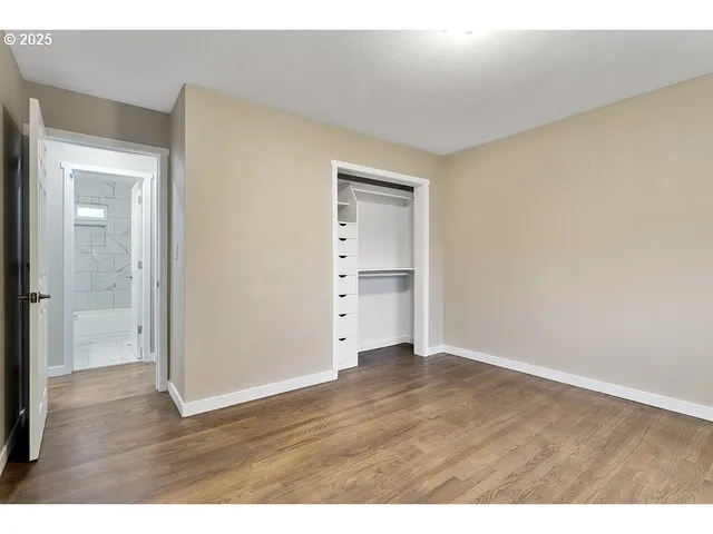 a view of an empty room and wooden floor