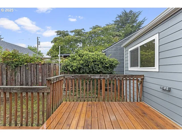 a view of balcony with wooden floor and fence