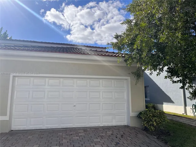 a couple of potted plants in front of door