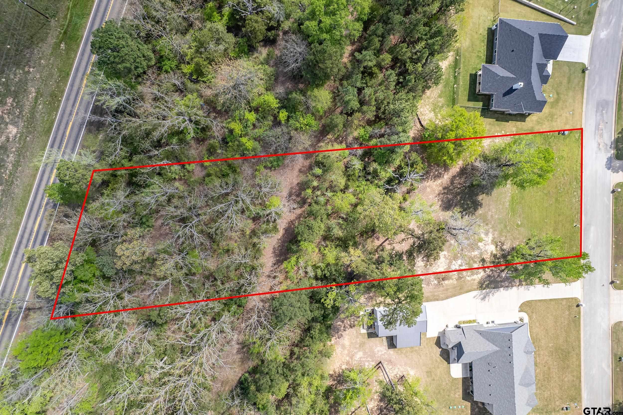 24070 Sun Ridge Road Lindale, TX 75771 - Photo 19 of 20 a view of a yard with plants and wooden fence